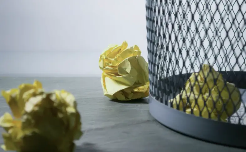 focus-photo-of-yellow-paper-near-trash-can-850216