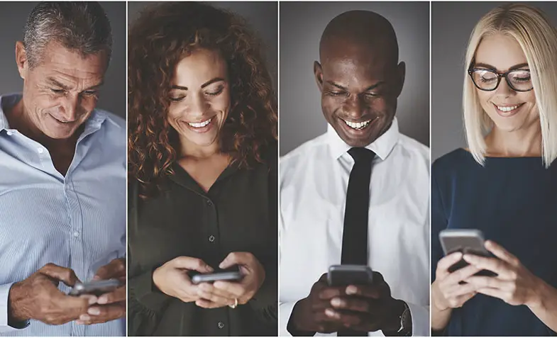 Smiling group of diverse businesspeople sending text messages