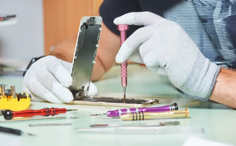 smart phone repair. repairman hands with screwdriver