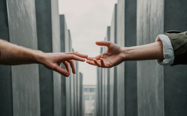 Two hands reaching each other